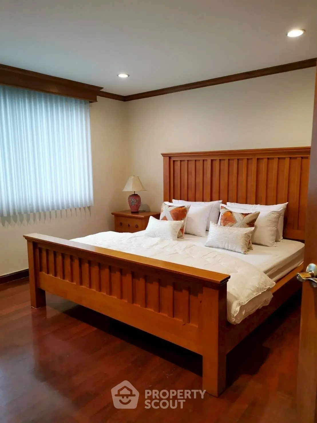 Cozy bedroom with wooden bed frame and elegant decor
