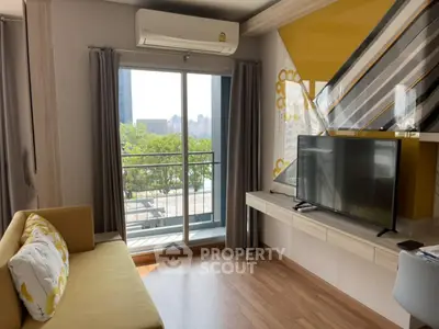Modern living room with balcony and city view, featuring stylish decor and natural light.