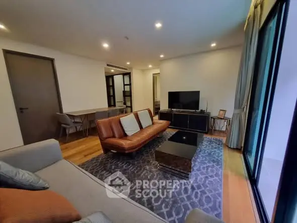 Spacious modern living room with stylish furniture and large windows