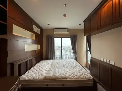 Spacious bedroom with wooden accents and city view from large window