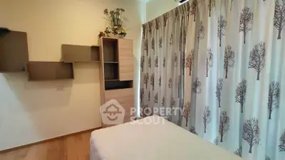 Cozy bedroom with modern decor and tree-patterned curtains