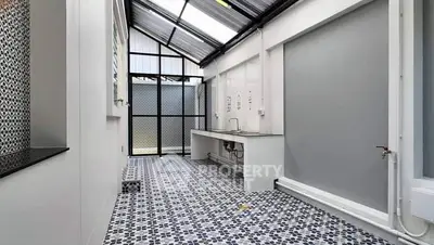 Spacious modern utility area with stylish patterned flooring and ample natural light.