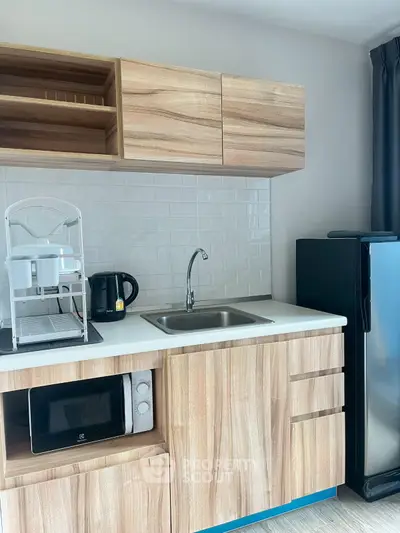 Modern compact kitchen with wooden cabinets and appliances