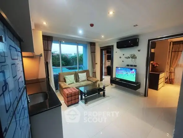 Modern living room with sleek design and large windows offering natural light.