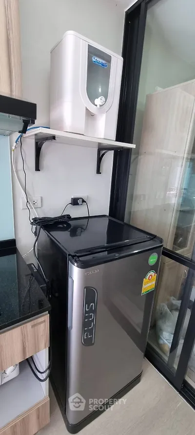 Modern kitchen corner with sleek fridge and water purifier setup