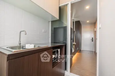 Modern kitchen with sleek cabinetry and open layout in a stylish apartment