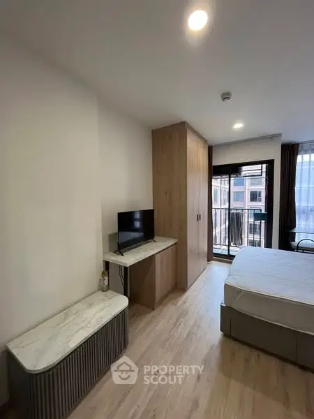 Modern bedroom with balcony view and sleek furnishings