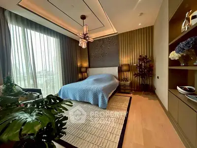 Luxurious bedroom with elegant decor and large window offering natural light