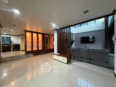 Spacious modern living room with sleek design and ample natural light, perfect for family gatherings.