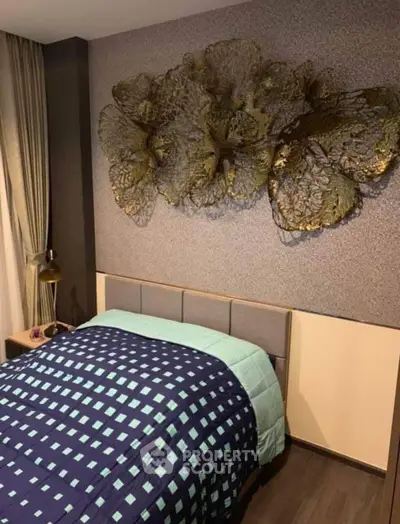 Stylish bedroom with modern decor and artistic wall feature, perfect for a cozy and elegant living space.