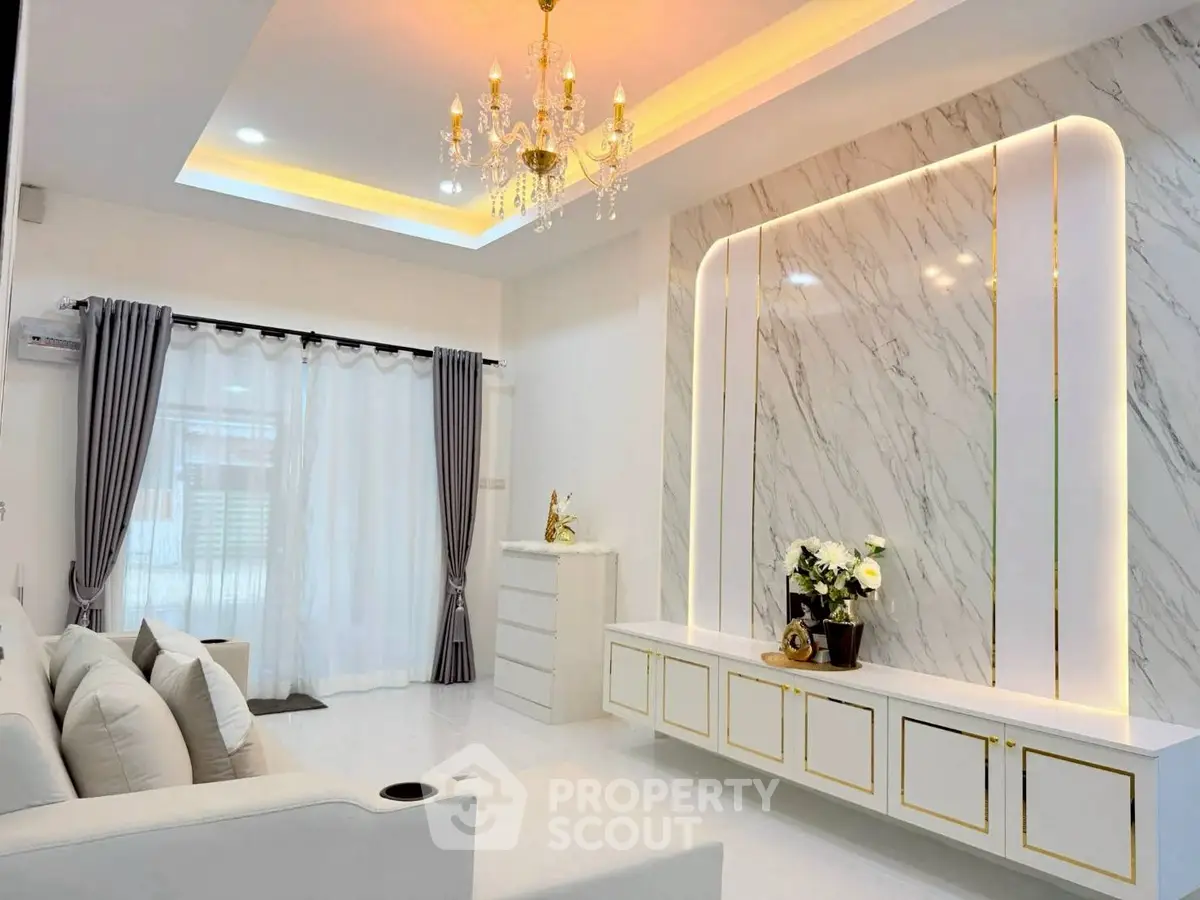 Luxurious living room with elegant chandelier and marble accent wall