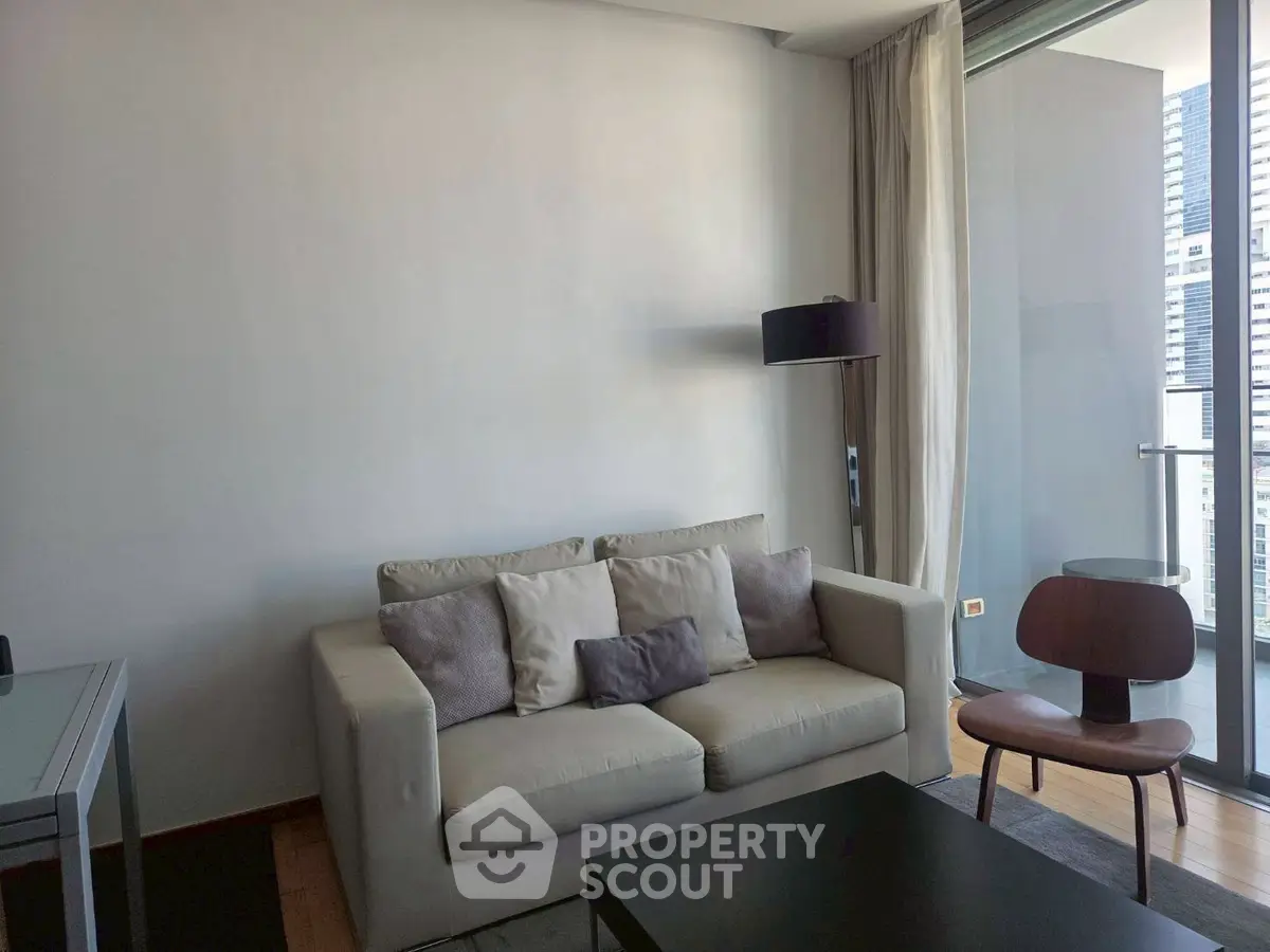 Modern living room with cozy sofa and balcony view in urban apartment