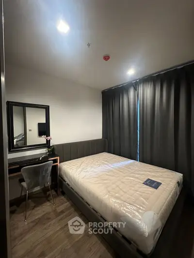 Modern bedroom with stylish decor and natural light, featuring a comfortable bed and elegant furnishings.