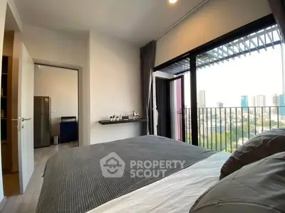 Modern bedroom with city view and balcony access
