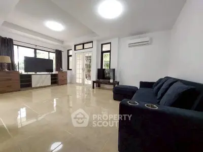 Spacious modern living room with sleek furniture and large windows