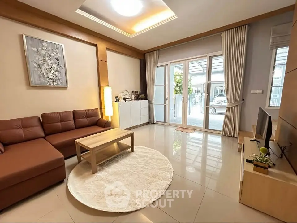 Spacious modern living room with large windows and elegant decor