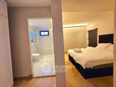 Modern bedroom with ensuite bathroom featuring elegant design and cozy ambiance
