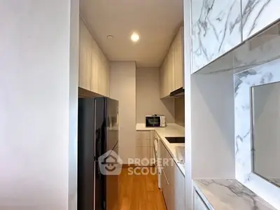 Modern kitchen with sleek appliances and marble accents