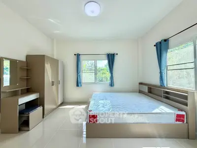 Spacious bedroom with large windows and modern furniture, perfect for natural light lovers.