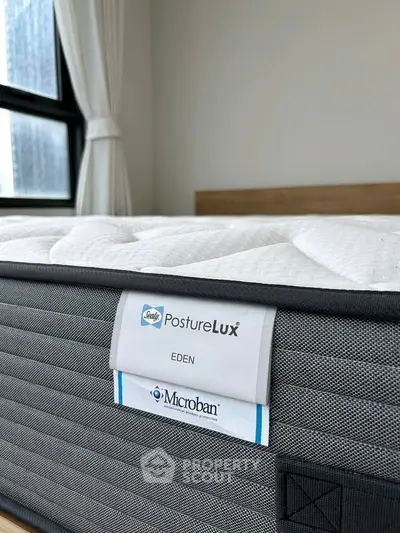 Luxurious bedroom featuring a premium PostureLux mattress with Microban protection, perfect for restful sleep.