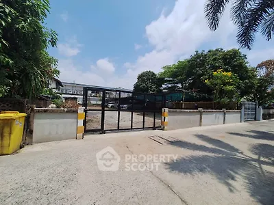 Spacious vacant lot with gated entrance, ideal for development in a serene neighborhood.