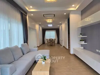 Spacious modern living room with elegant decor and ample natural light.