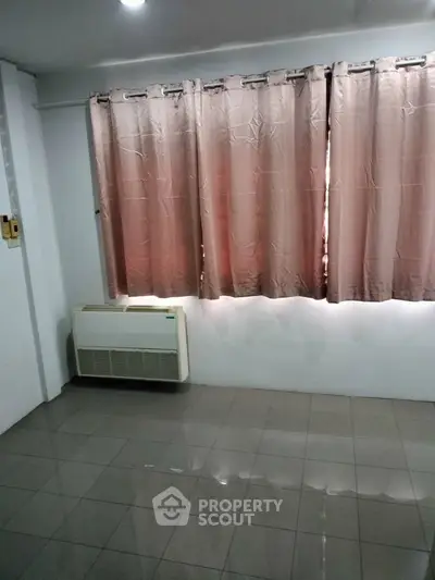 Spacious room with tiled floor and large window with curtains, ideal for customization.
