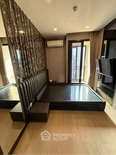Luxurious bedroom with modern design and city view balcony access.