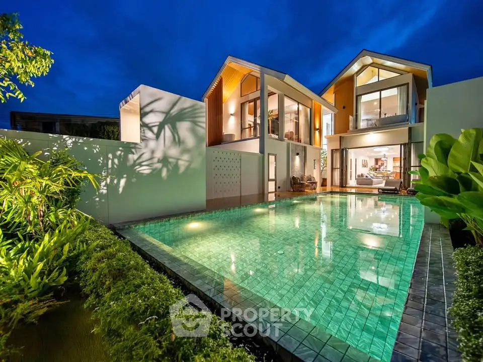 Luxurious modern villa with stunning pool and lush garden at twilight, perfect for serene living.