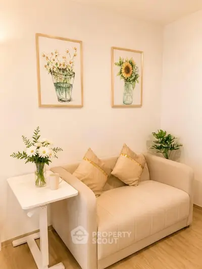 Charming living room with cozy beige sofa, floral artwork, and elegant decor for a warm ambiance.