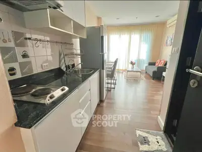 Charming open-layout kitchen and living area with modern appliances and cozy decor.