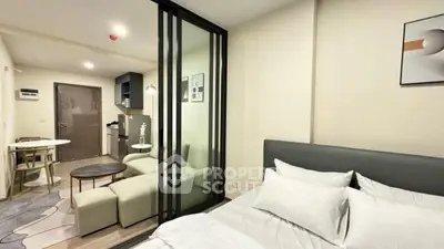 Modern studio apartment with open layout, featuring cozy bedroom and stylish living area.