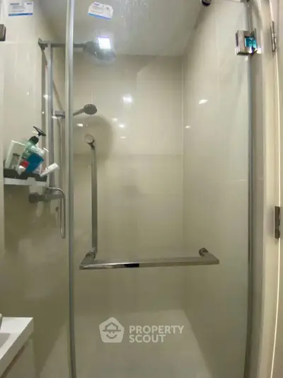 Modern bathroom shower with glass door and sleek fixtures in a contemporary home.