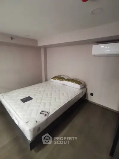 Cozy bedroom with modern air conditioning and minimalist design.