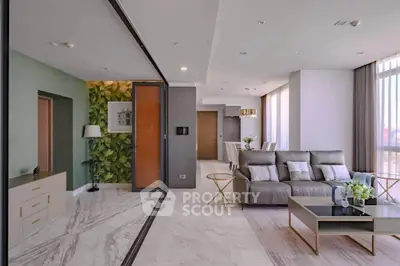 Luxurious modern living room with elegant decor and large windows offering natural light.