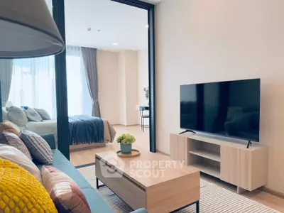 Modern living room with sleek TV setup and cozy bedroom view