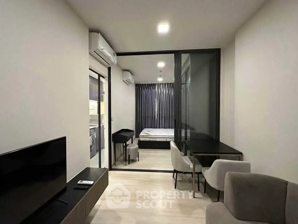Modern apartment interior with sleek design and open layout, featuring a cozy living area and stylish bedroom.