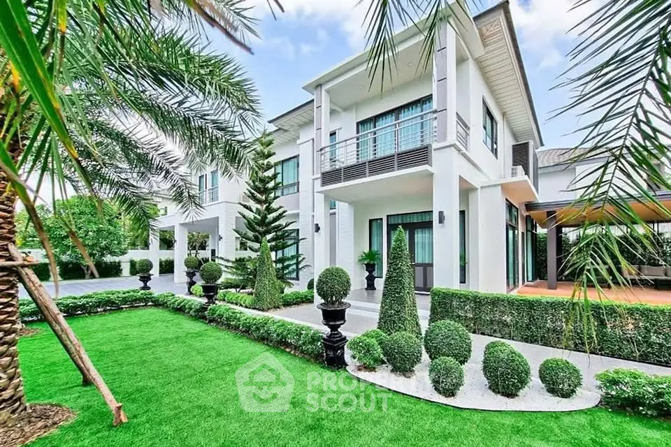 Luxurious modern home with manicured garden and elegant facade, perfect for upscale living.