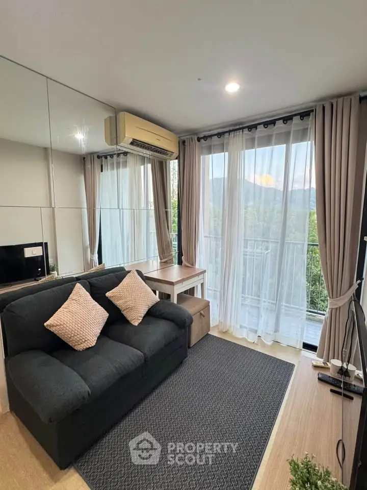 Chic living room with modern decor and balcony view, perfect for urban living.