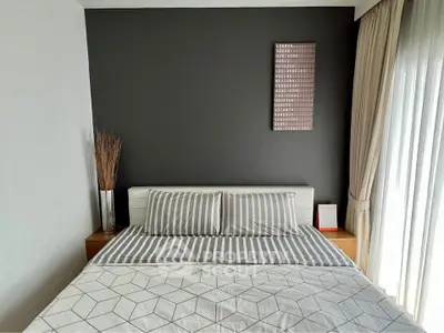 Modern bedroom with stylish decor and natural light