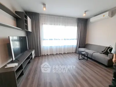 Modern living room with sleek furniture and large window for natural light