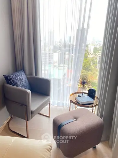 Cozy corner with city view, featuring modern chair and ottoman, perfect for relaxation.