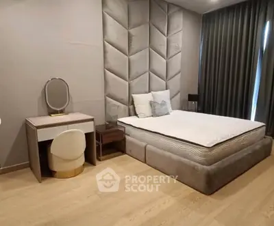 Luxurious bedroom with plush headboard and elegant vanity set, perfect for modern living.