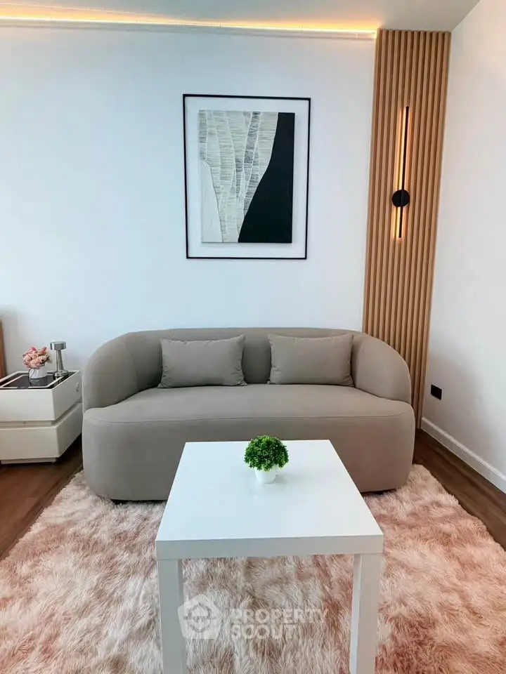 Modern living room with cozy sofa, stylish decor, and elegant lighting