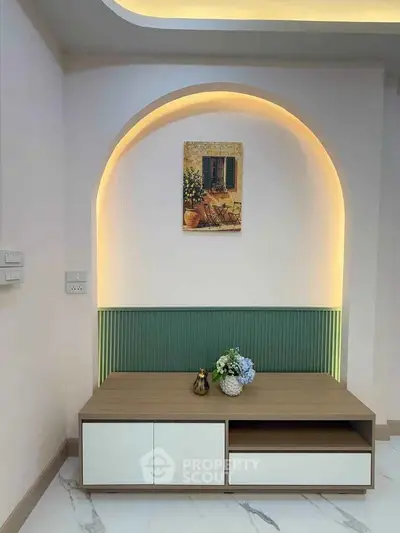 Elegant interior design with modern furniture and ambient lighting, featuring a stylish wall niche and decorative artwork.