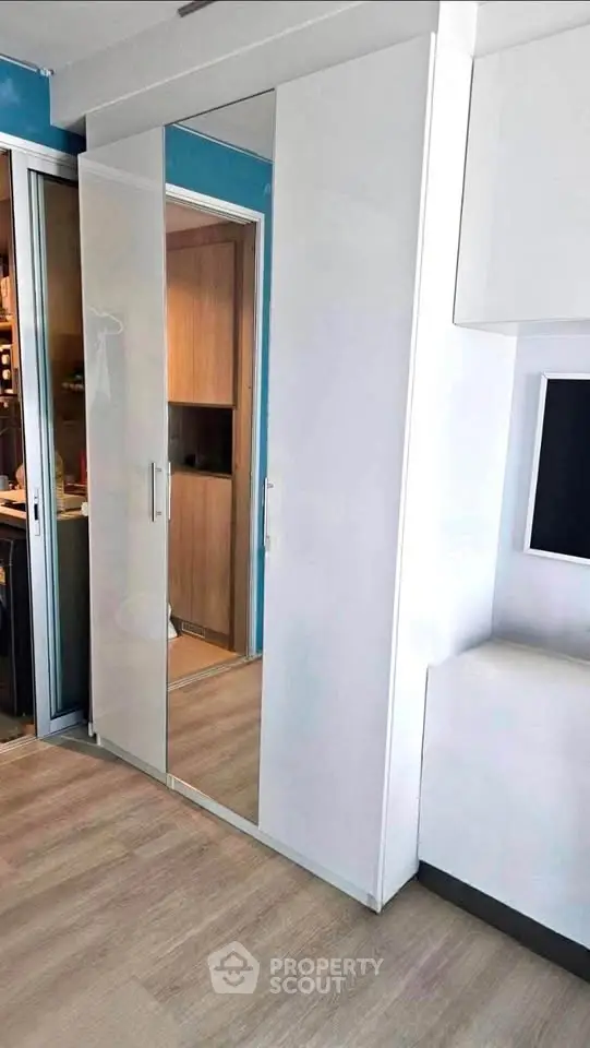 Modern interior with sleek wardrobe and wooden flooring in a stylish apartment.
