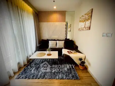 Stylish living room with modern decor, cozy sofa, and elegant rug, perfect for relaxation and entertaining.