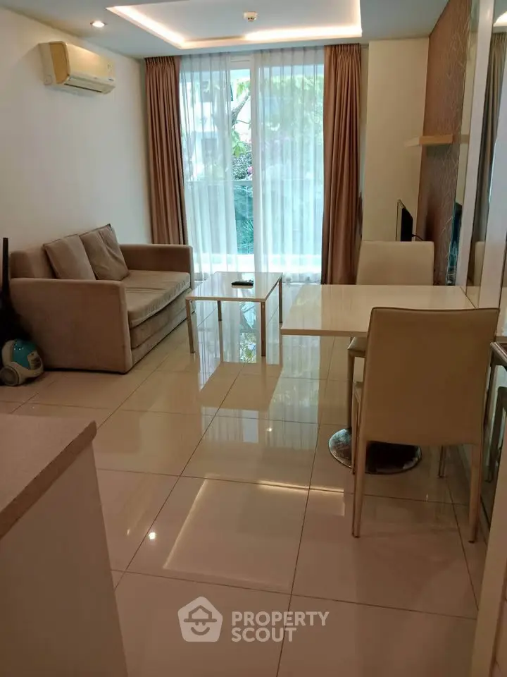 Modern living room with sleek furniture and large window for natural light