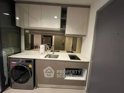 Modern compact kitchen with washing machine and sleek cabinetry