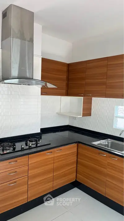 Modern kitchen with sleek wooden cabinets and gas stove